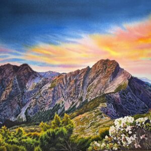 A large vibrant watercolor painting of a majestic purple mountain illuminated by a golden and pink sunrise, with blooming alpine flowers in the foreground.